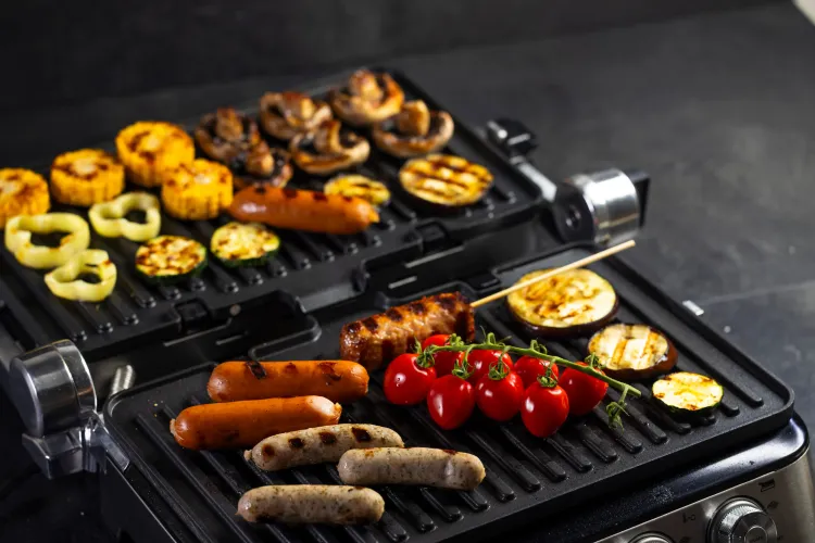 Aufgeklappter Kontaktgrill mit Gemüse und Fleisch